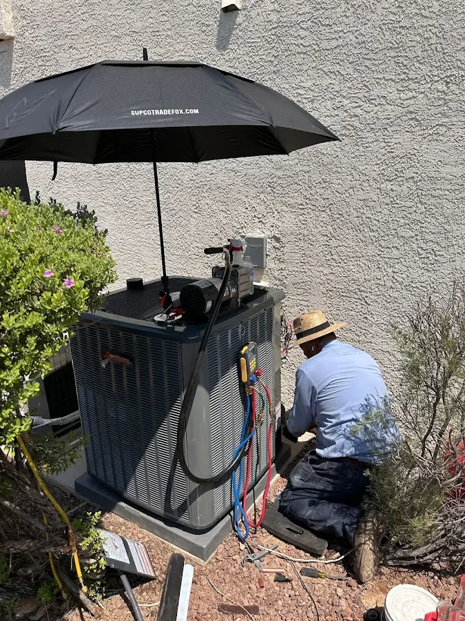 HVAC technician performing outdoor AC maintenance in Swampscott